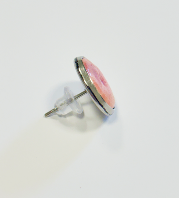 Lutscher mit rosa Motiv und silbernem Stab auf durchsichtiger Kunststoffstütze